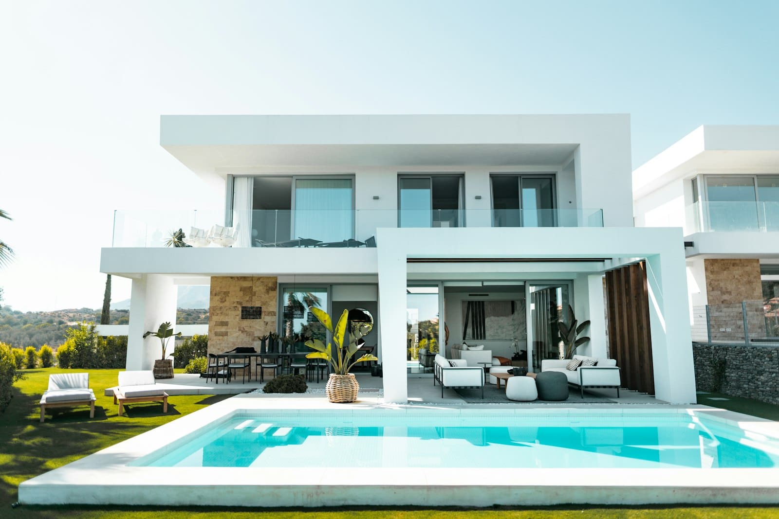 Modern home with a concrete pool patio and surround designed for New England conditions