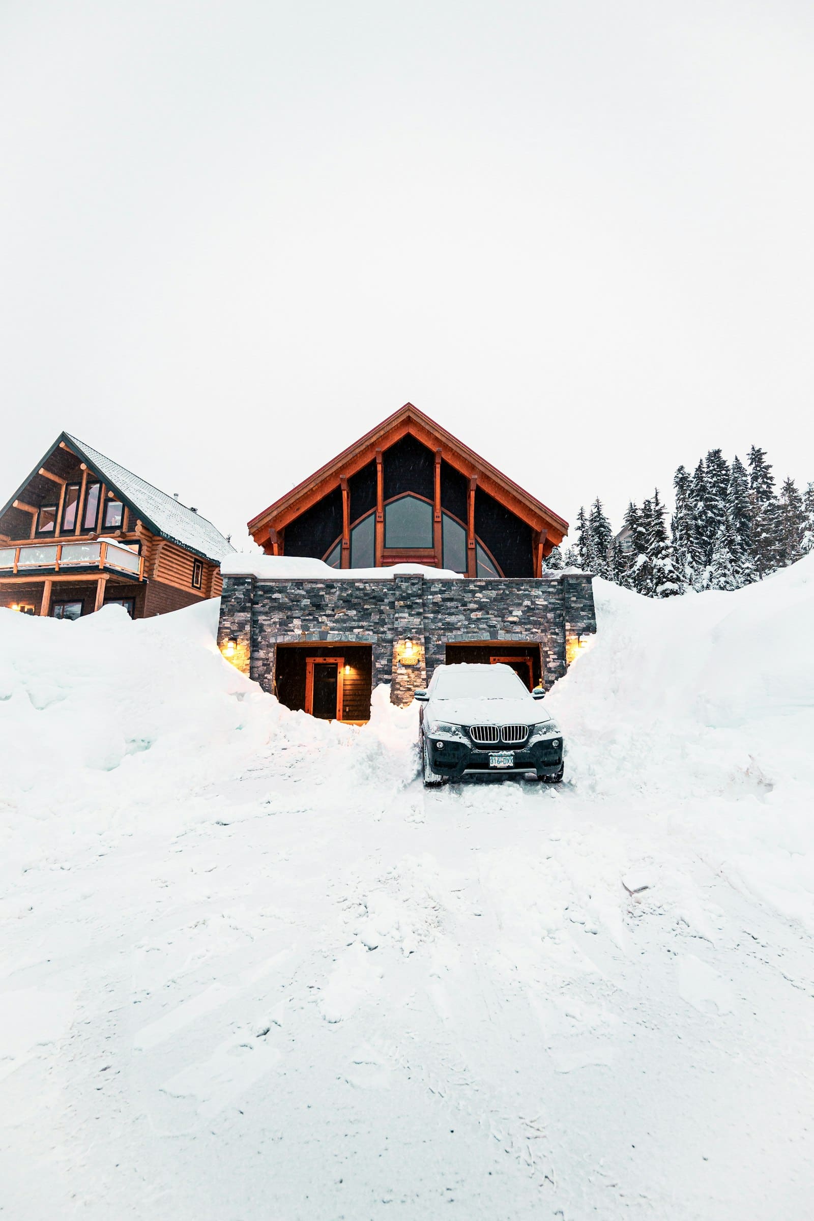 Snow-covered New Hampshire home and driveway buried in deep winter snow — illustrating why winter is not the best time to pour concrete in New Hampshire