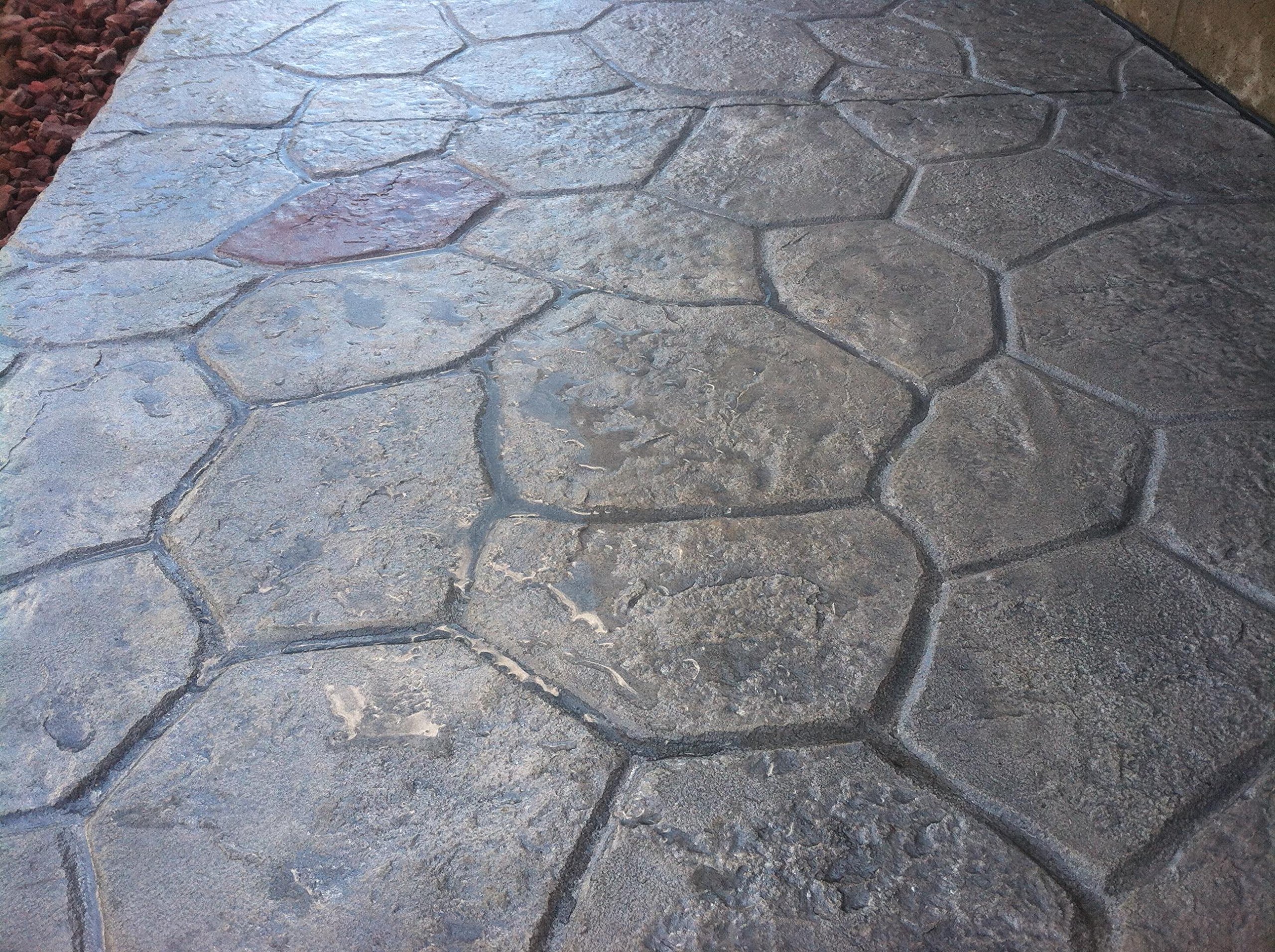 Stamped concrete patio finish with stone pattern