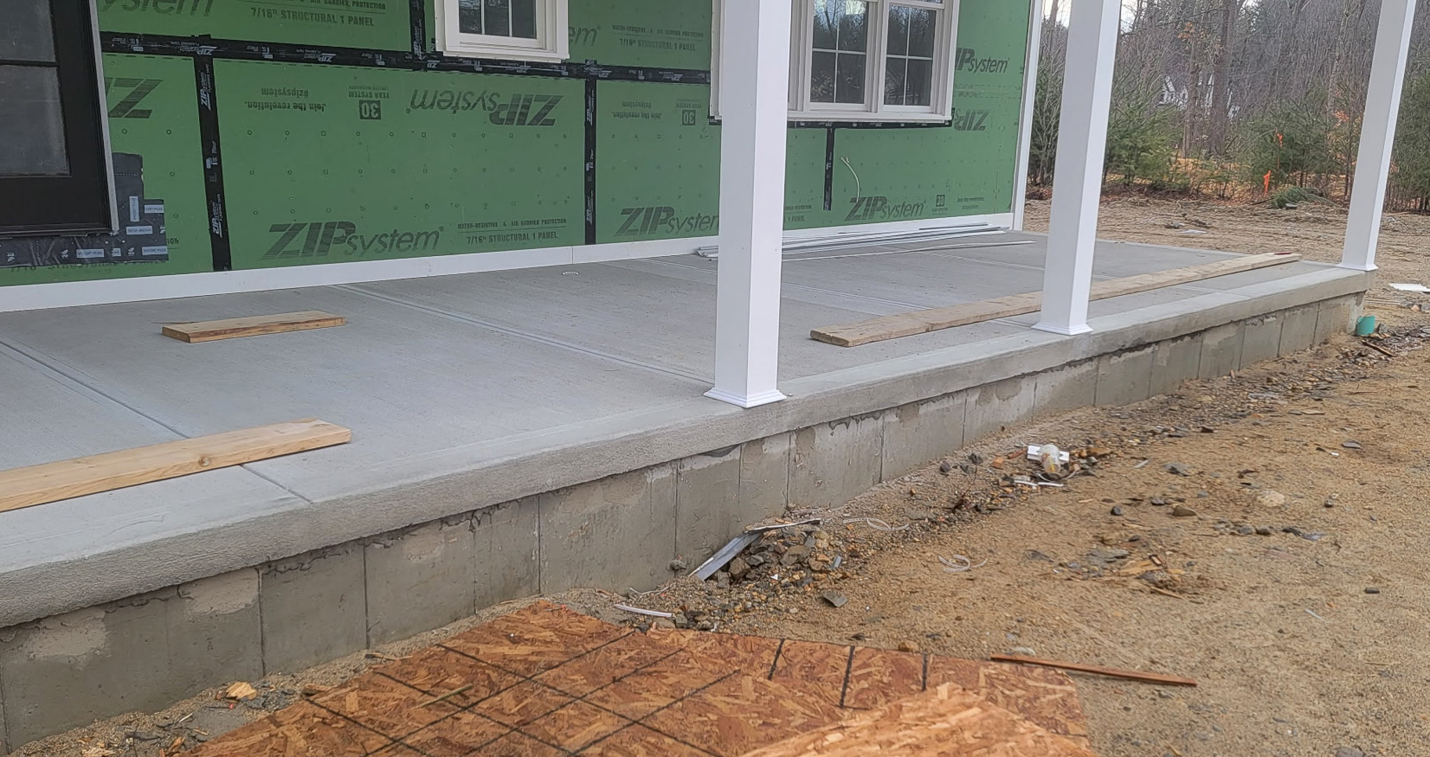 Concrete driveway leading to a home in New Hampshire