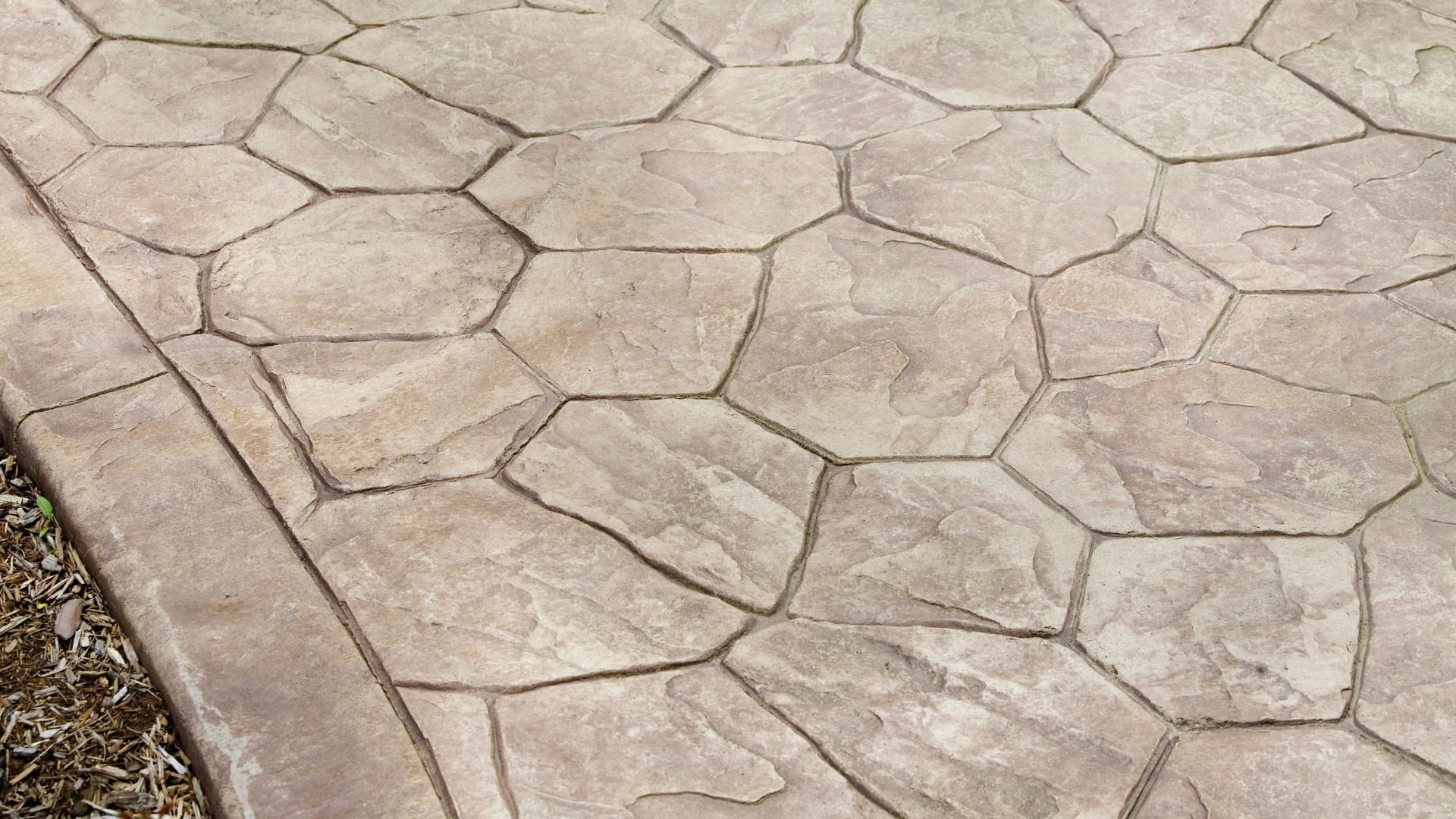 Stamped concrete patio with stone-like irregular pattern and edge